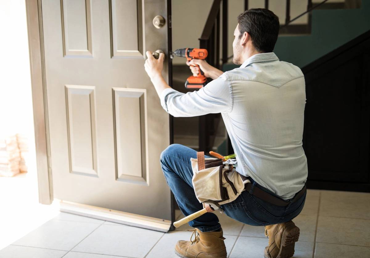 our expert handyman installing door lock